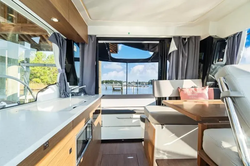 Slide: The Image of Interior of 2021 Jeanneau NC 1095 yacht with scenic water view through windows. - 19