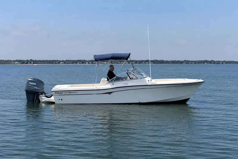 Slide: The Image of 2006 Grady-White Freedom 225 boat on calm water with Yamaha outboard motor. - 1
