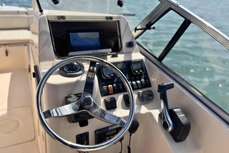 Slide: The Image of Steering console of 2006 Grady-White Freedom 225 boat with ocean view. - 10