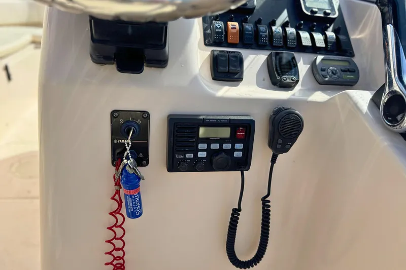 Slide: The Image of Control panel of a 2006 Grady-White Freedom 225 boat with Yamaha ignition and marine radio. - 11