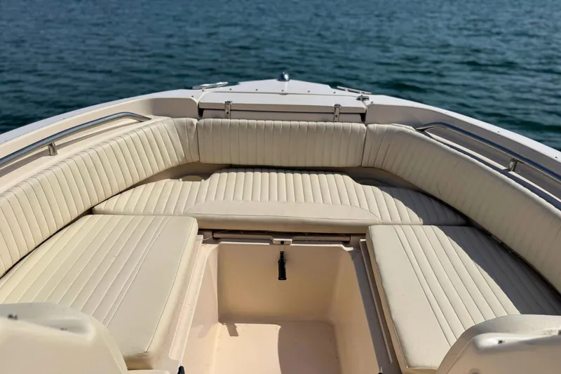 Slide: The Image of Bow seating area of a 2006 Grady-White Freedom 225 boat on calm water. - 14