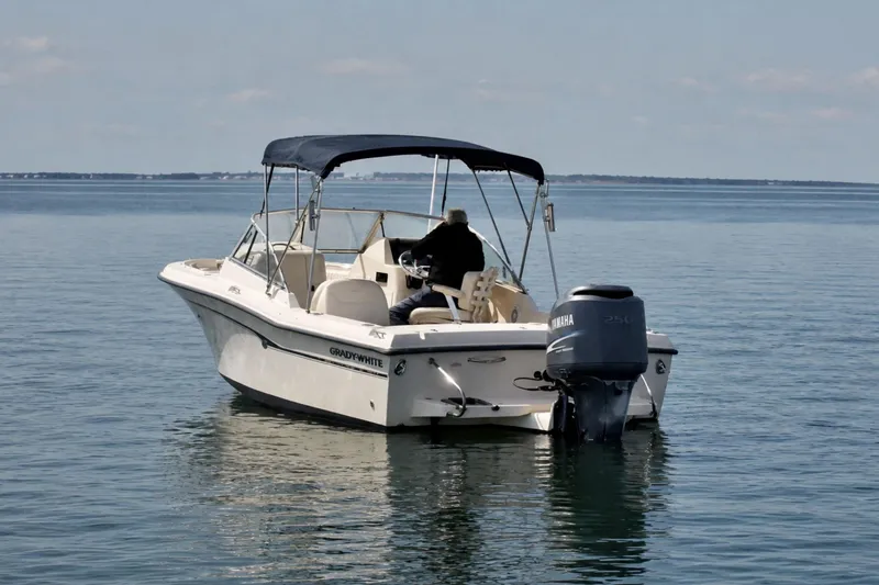 Slide: The Image of 2006 Grady-White Freedom 225 boat on calm water with Yamaha outboard motor. - 3