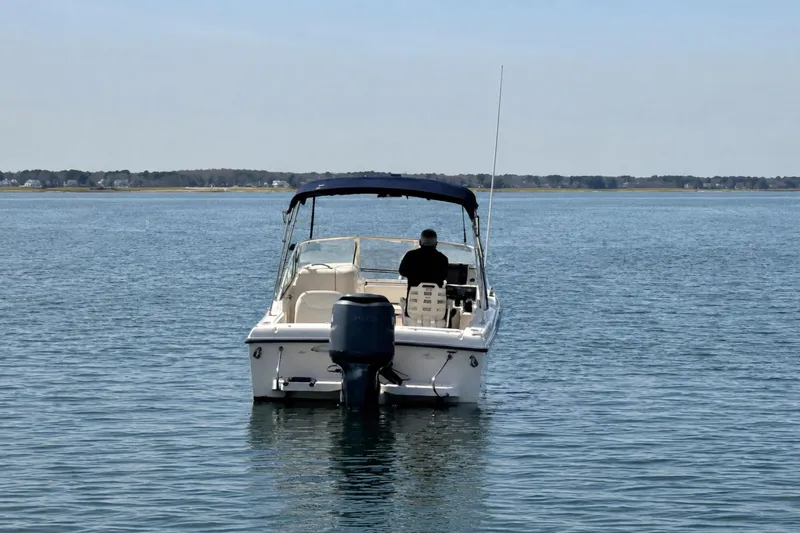 Slide: The Image of 2006 Grady-White Freedom 225 boat on calm water, rear view with canopy. - 7