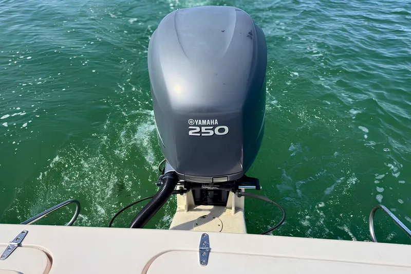 Slide: The Image of Yamaha 250 outboard motor on 2006 Grady-White Freedom 225 boat in green water. - 8