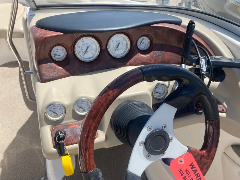 Slide: The Image of Dashboard of a 2006 Glastron GX 205 boat with wood trim. - 10