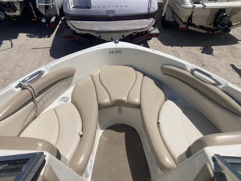 Slide: The Image of Interior view of a 2006 Glastron GX 205 boat with beige seating. - 12