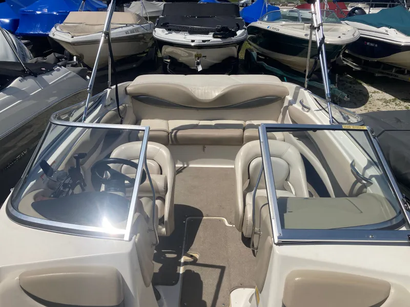 Slide: The Image of 2006 Glastron GX 205 boat interior, parked among other boats. - 13