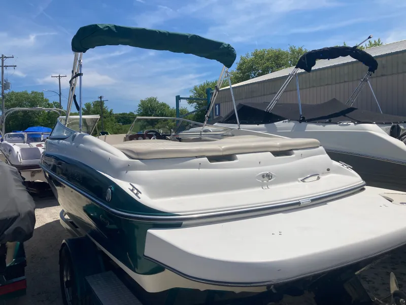 Slide: The Image of 2006 Glastron GX 205 boat with green canopy outdoors. - 3