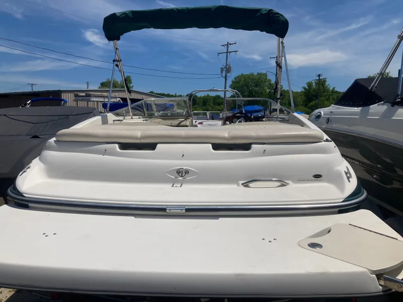 Slide: The Image of 2006 Glastron GX 205 boat with green canopy at dock. - 4