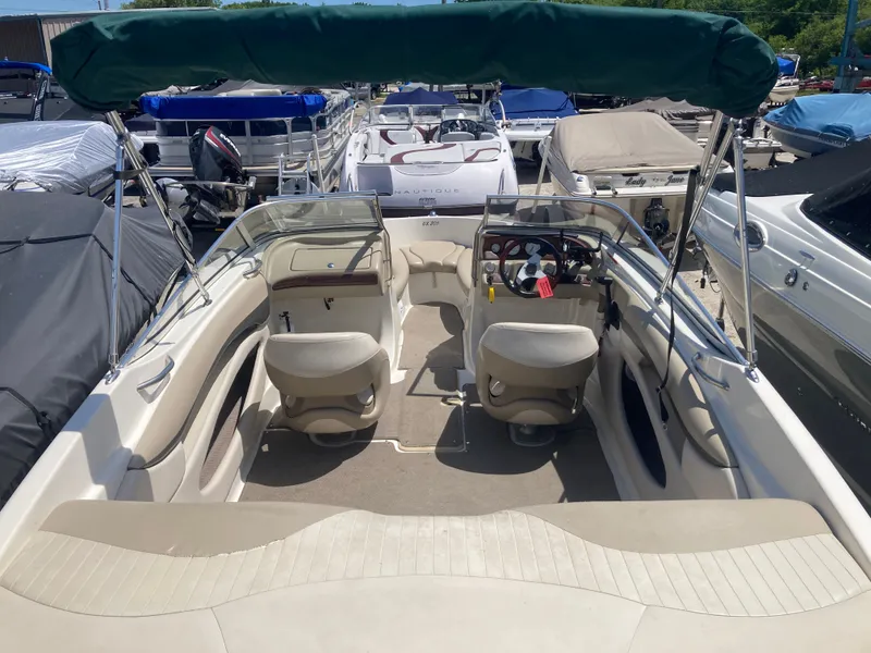 Slide: The Image of Interior view of a 2006 Glastron GX 205 boat with green sunshade. - 6