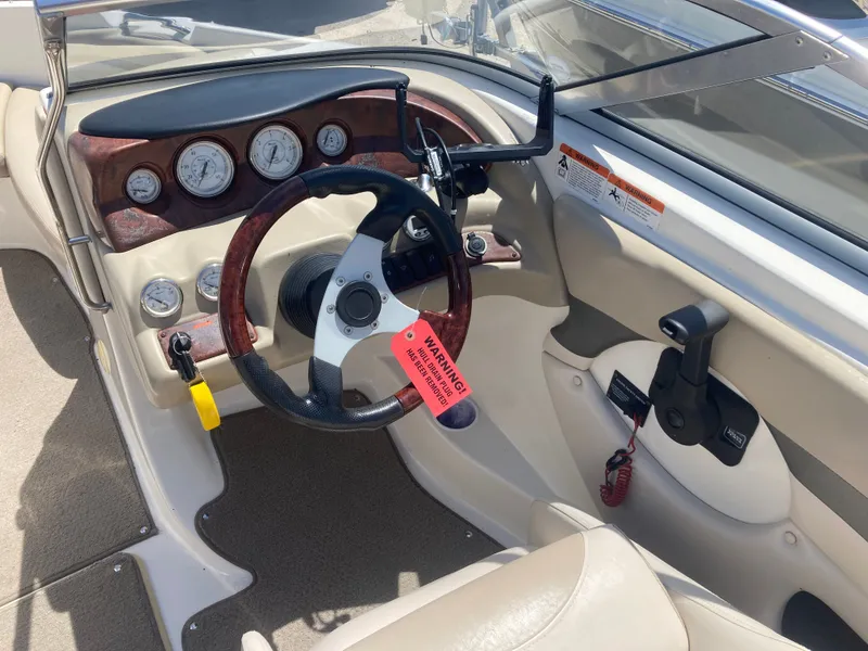 Slide: The Image of Interior of a 2006 Glastron GX 205 boat with steering wheel and dashboard. - 9