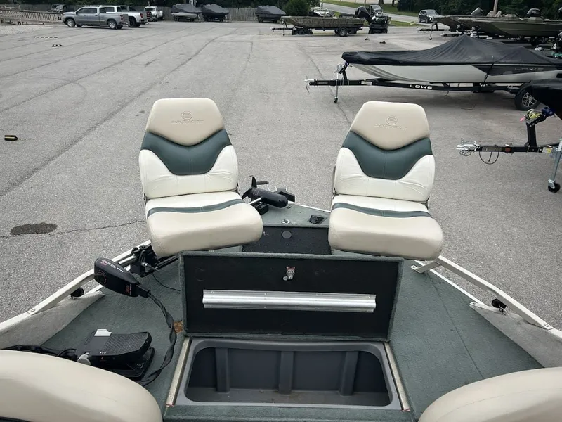 Slide: The Image of 2001 Sun Tracker Party Deck boat with two seats on parking lot. - 10