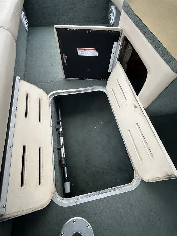 Slide: The Image of 2001 Sun Tracker Party Deck storage compartment with open hatches. - 15