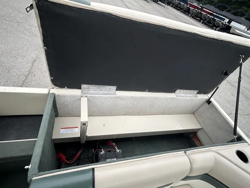 Slide: The Image of 2001 Sun Tracker Party Deck boat with open storage compartment lid. - 17