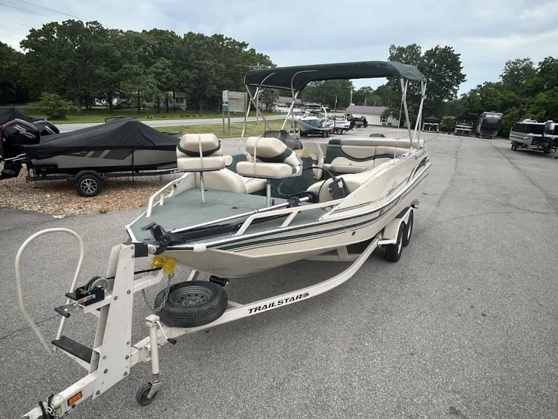 Slide: The Image of 2001 Sun Tracker Party Deck boat parked on trailer. - 5