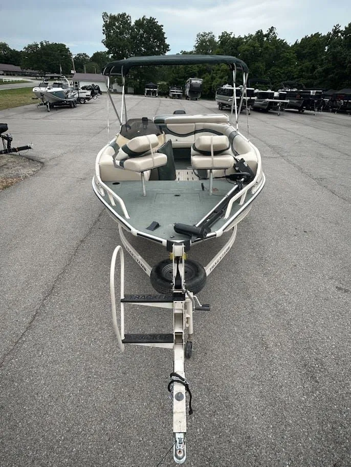 Slide: The Image of 2001 Sun Tracker Party Deck boat on trailer, parking lot view. - 6