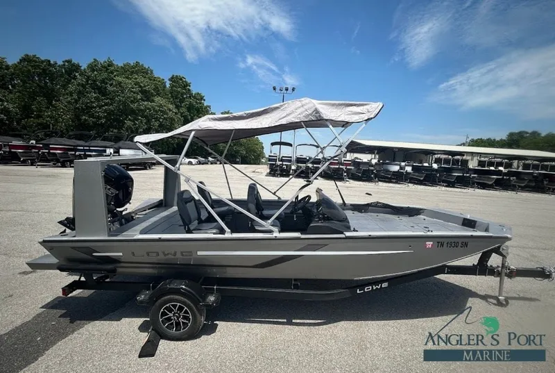 The Image of 2025 Lowe Outlet 20 boat with canopy on trailer. - 1