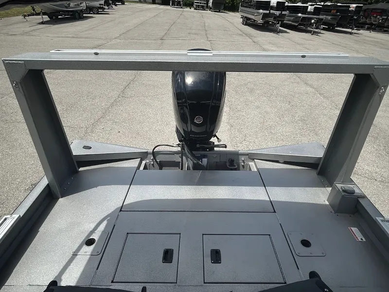 Slide: The Image of Lowe Outlet 20 boat 2025 with outboard motor on parking lot. - 13