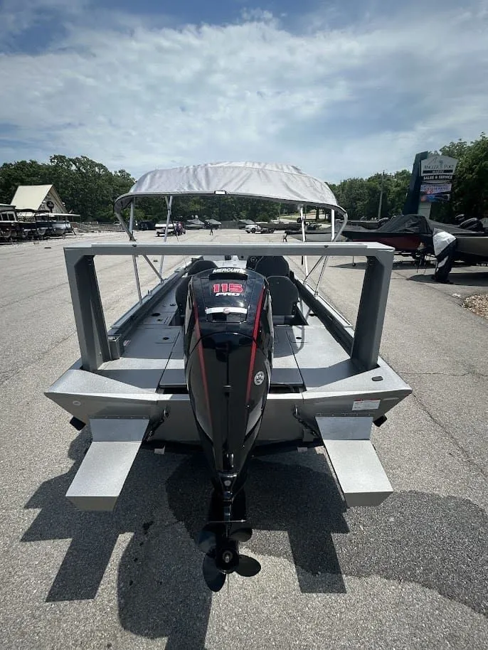 Slide: The Image of Lowe Outlet 20 boat 2025 with outboard motor on parking lot. - 3
