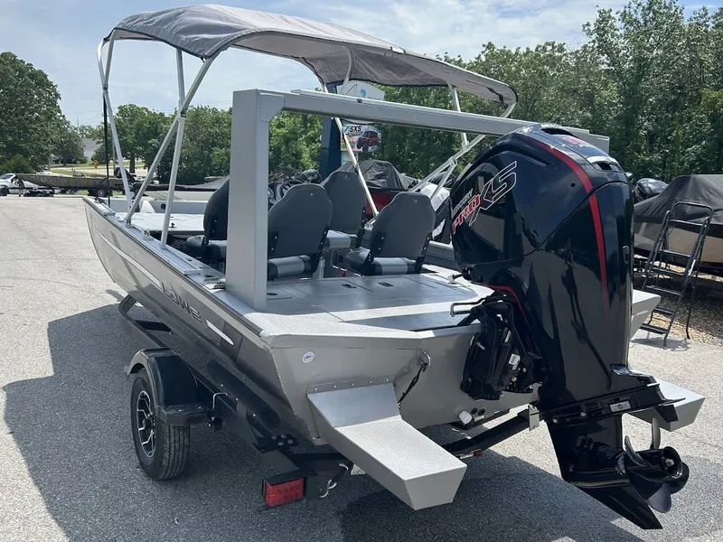 Slide: The Image of Lowe Outlet 20 boat 2025 with outboard motor on trailer. - 4