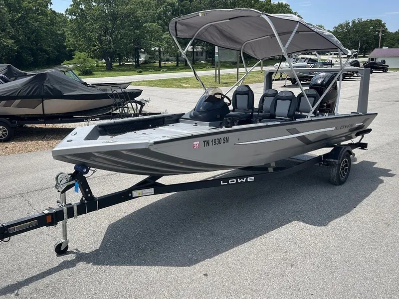 Slide: The Image of 2025 Lowe Outlet 20 boat with trailer in parking lot. - 5