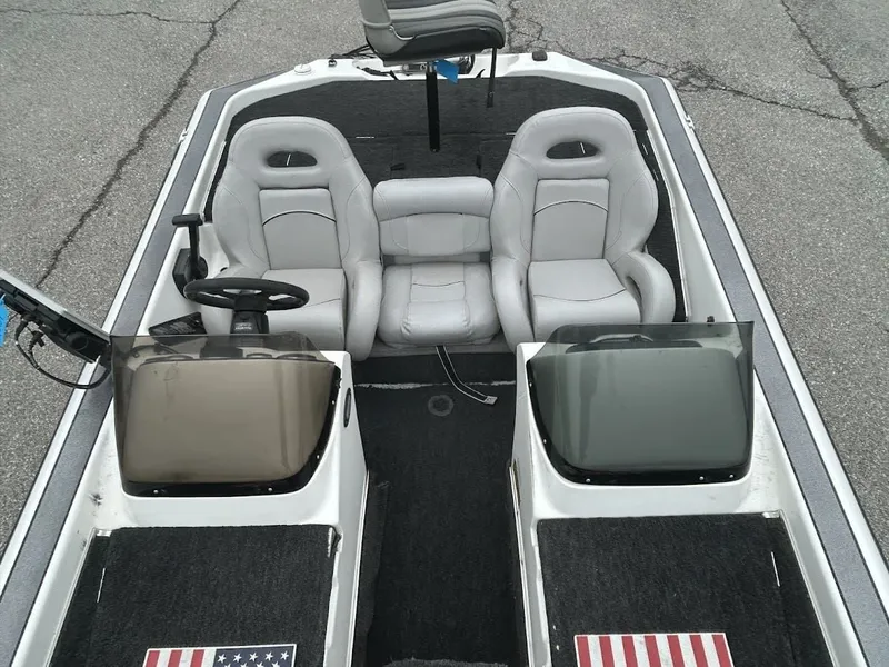 Slide: The Image of Interior of a 1997 Champion 191 DC boat with gray seats. - 12