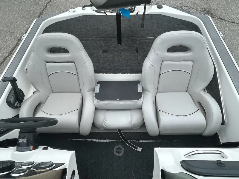 Slide: The Image of Interior of a 1997 Champion 191 DC boat with two seats. - 13