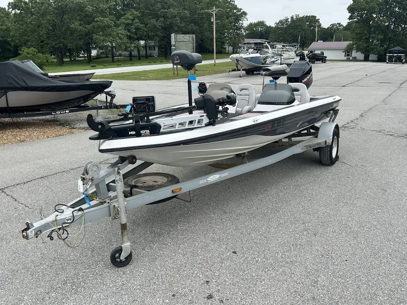 Slide: The Image of 1997 Champion 191 DC boat parked on trailer outdoors. - 5
