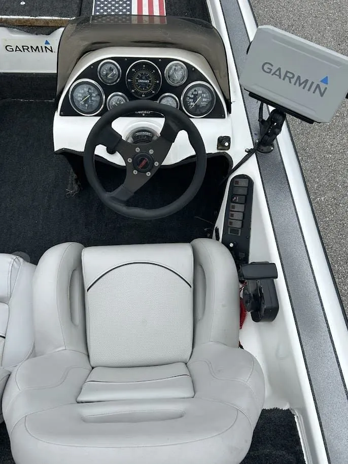 Slide: The Image of Interior view of a 1997 Champion 191 DC boat with Garmin device. - 7