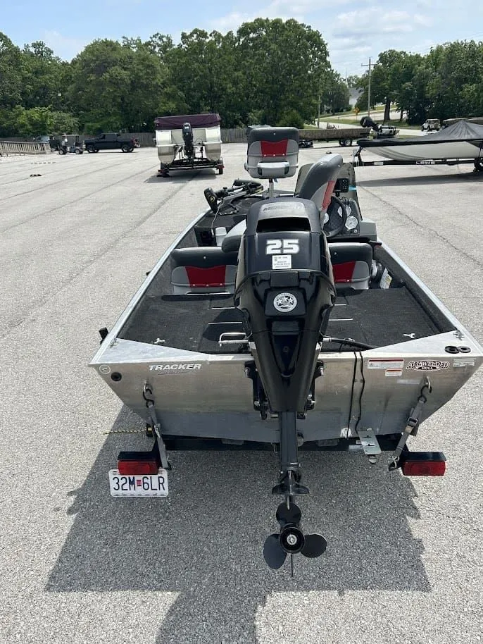 Slide: The Image of 2016 Tracker Pro 160 boat with 25 HP motor in parking lot. - 3