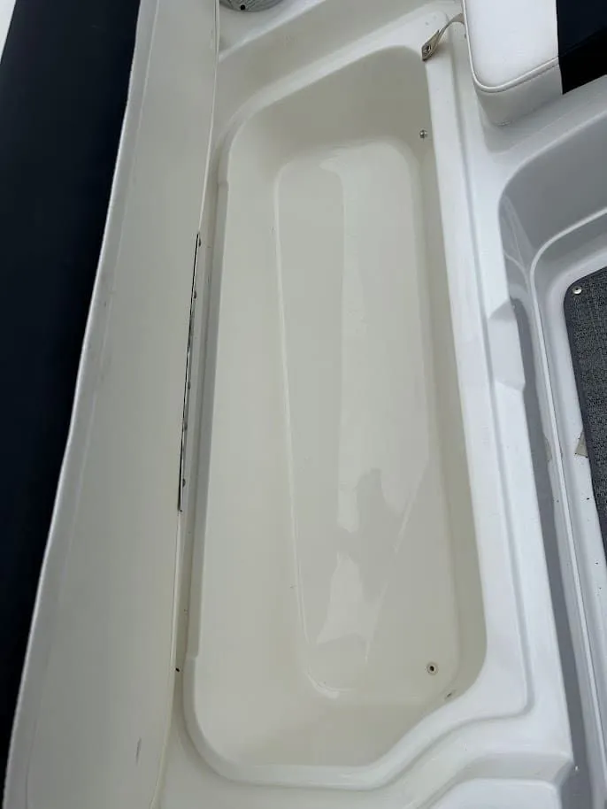 Slide: The Image of Interior of a 2019 Tahoe 2150 boat, white storage compartment. - 10