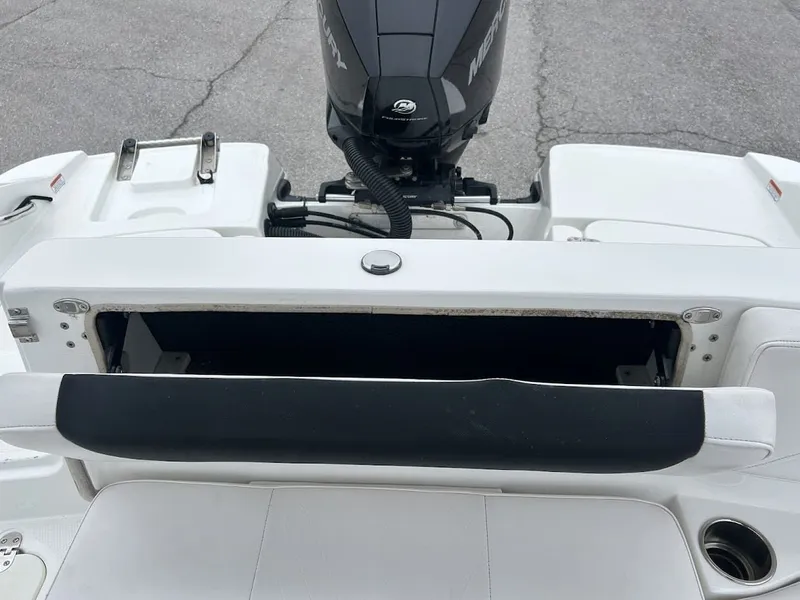 Slide: The Image of 2019 Tahoe 2150 boat with open storage compartment and Mercury engine. - 15