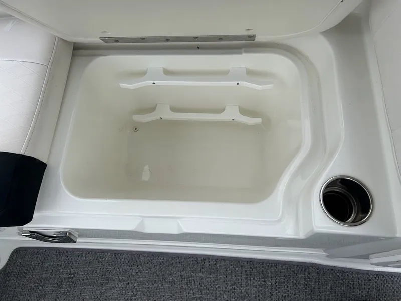 Slide: The Image of Interior of 2019 Tahoe 2150 boat with storage compartment and cup holder. - 16