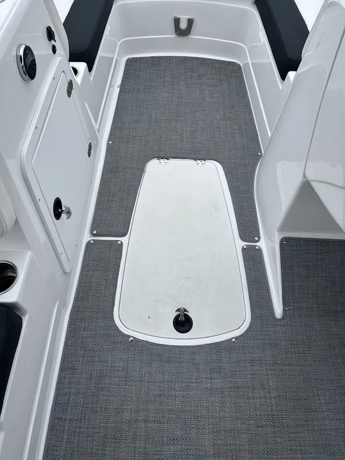 Slide: The Image of Interior of a 2019 Tahoe 2150 boat with gray carpet flooring. - 18