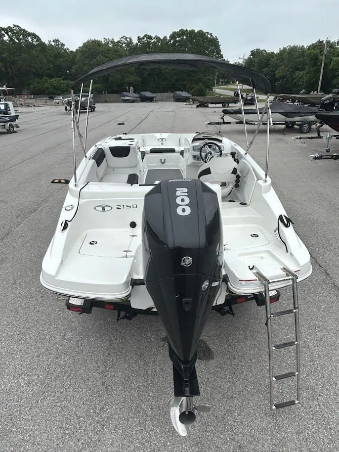 Slide: The Image of 2019 Tahoe 2150 boat with outboard motor and bimini top. - 3
