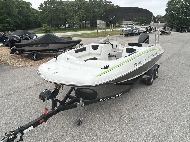 Slide: The Image of 2019 Tahoe 2150 boat on trailer parked outdoors. - 4