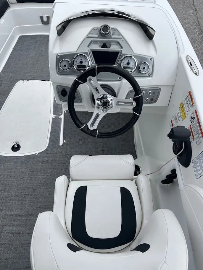 Slide: The Image of Interior of a 2019 Tahoe 2150 boat with steering console. - 6