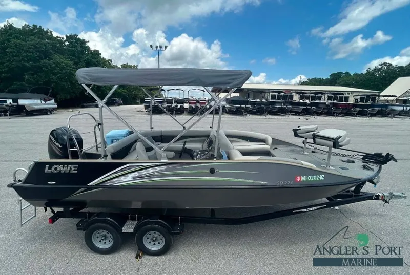 The Image of 2018 Lowe Sport Deck 224 boat on trailer outdoors. - 1