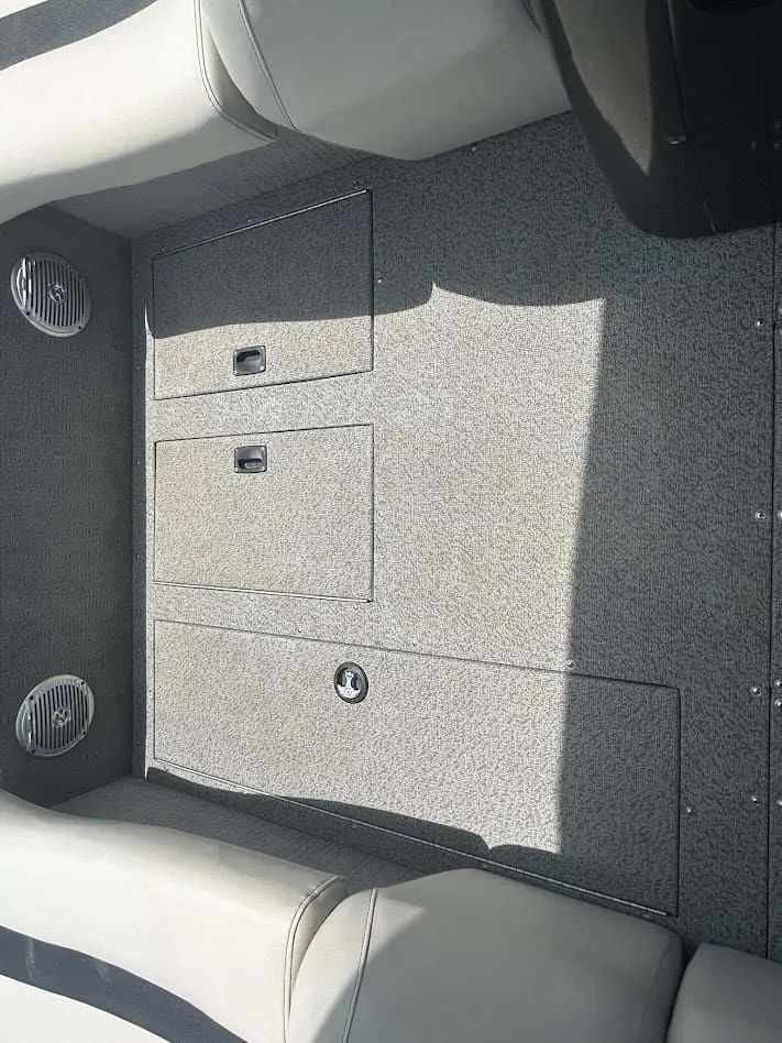 Slide: The Image of Interior of a 2018 Lowe Sport Deck 224 boat with gray carpet. - 8