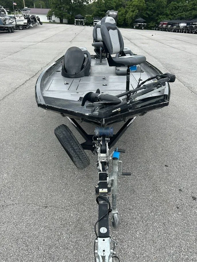 Slide: The Image of 2020 Stinger 175C boat on trailer, gray seats, parking lot. - 6