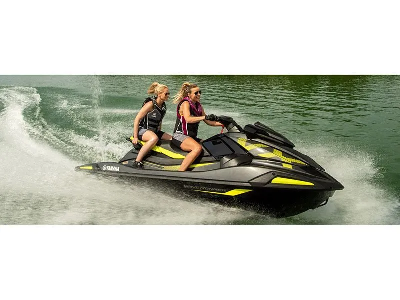 Slide: The Image of Two people riding 2022 Yamaha VX Deluxe jet ski on water. - 10