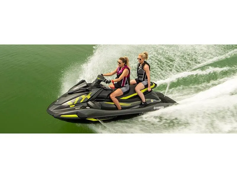 Slide: The Image of Two people riding 2022 Yamaha VX Deluxe jet ski on water. - 8