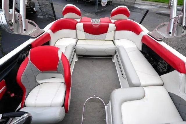 Slide: The Image of 2015 MasterCraft X20 boat interior with red and white seating, spacious and stylish design. - 12
