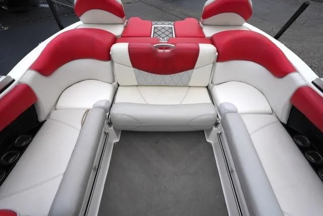 Slide: The Image of 2015 MasterCraft X20 boat interior with red and white seating, featuring diamond-patterned upholstery. - 16
