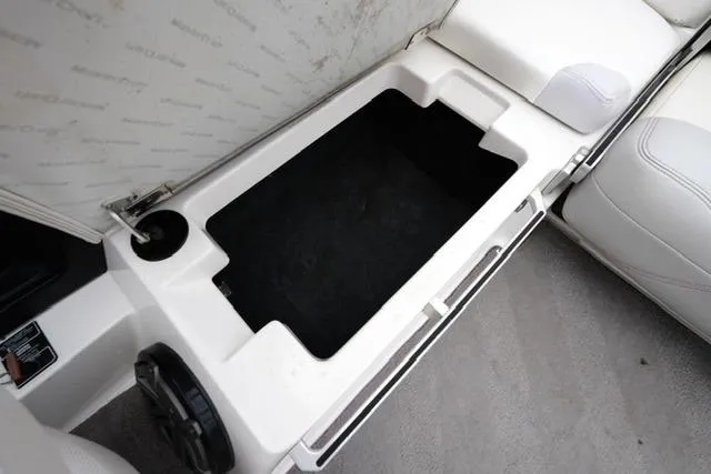 Slide: The Image of 2015 MasterCraft X20 boat storage compartment with white interior and speaker detail. - 19