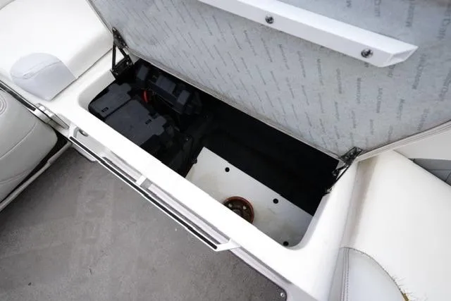 Slide: The Image of 2015 MasterCraft X20 boat storage compartment with battery and wiring. - 20