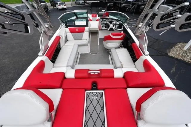 Slide: The Image of 2015 MasterCraft X20 boat interior with red and white seating, sleek design. - 8