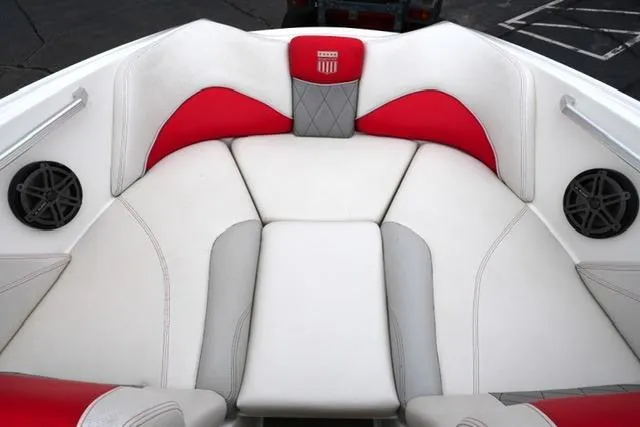 Slide: The Image of 2015 MasterCraft X20 boat interior with red and white seating and built-in speakers. - 9
