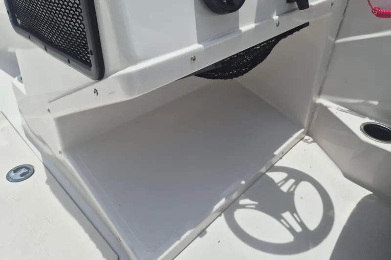 Slide: The Image of Storage compartment in a 2022 Starcraft SVX 171 OB boat, featuring a netted shelf. - 10