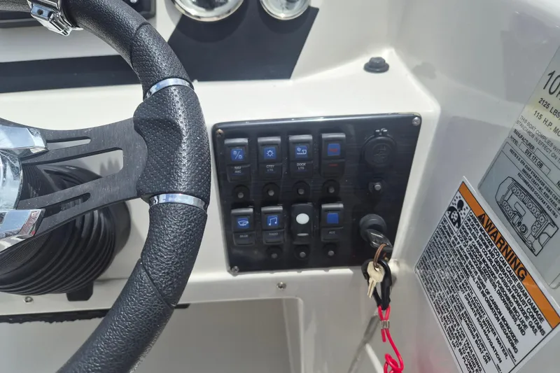 Slide: The Image of 2022 Starcraft SVX 171 OB boat dashboard with steering wheel and control panel. - 11